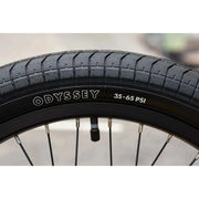 Close-up of Odyssey 20-inch BMX bike tire with 35-65 PSI pressure range on Sunday EX Arteaga complete bike rim