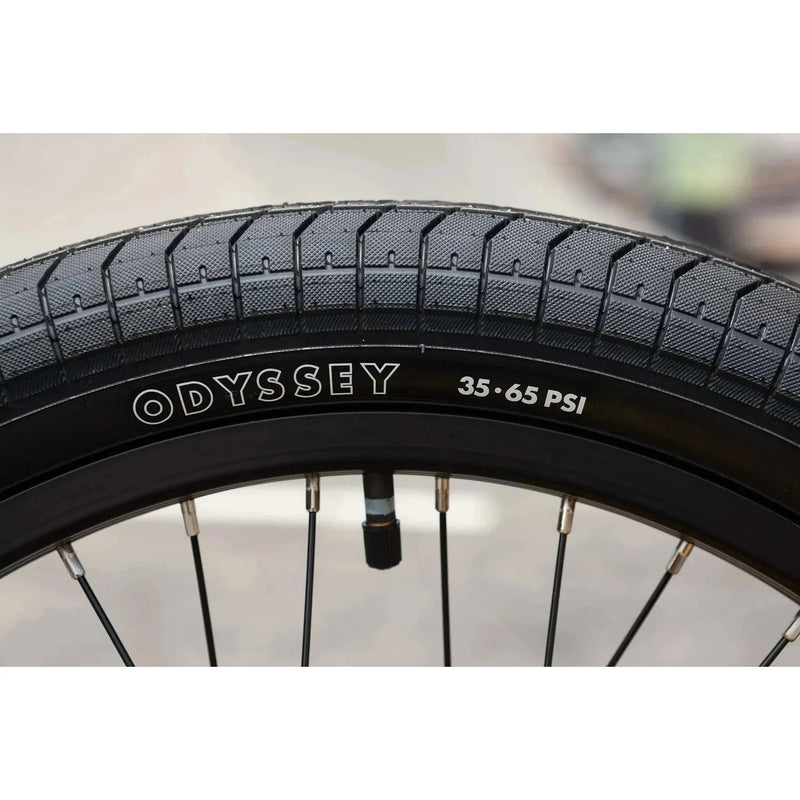 Close-up of Odyssey 20-inch BMX bike tire with 35-65 PSI pressure range on Sunday EX Arteaga complete bike rim