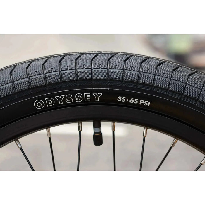 Close-up of Odyssey 20-inch BMX bike tire with 35-65 PSI pressure range on Sunday EX Arteaga complete bike rim