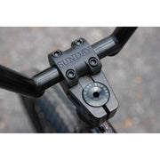 Close-up of black Sunday EX Elstran BMX bike handlebar stem with engraved branding and bolts