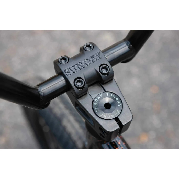 Close-up of black Sunday EX Elstran BMX bike handlebar stem with engraved branding and bolts