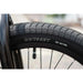 Close-up of Odyssey brand tire on Sunday EX Elstran 20" complete BMX bike wheel with black spokes and valve stem.