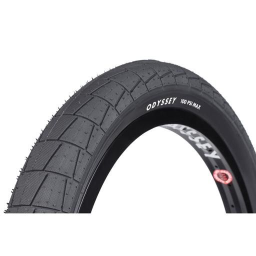 Odyssey Broc tire with large directional tread and R-Grip rubber, 100 PSI max, dual-ply sidewall