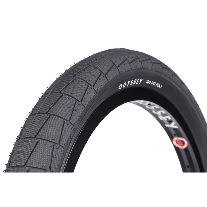 Odyssey Broc tire with large directional tread and R-Grip rubber, 100 PSI max, dual-ply sidewall