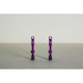 Pair of purple MTB tubeless presta valves with double air duct and metal caps on a beige background