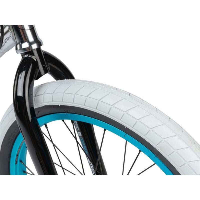 Close-up of white SALTPLUS 2.30” BURN tire with blue rim on RADIO ASTRON FS COMPLETE BIKE front fork.