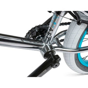 Close-up of RADIO ASTRON FS complete bike chrome frame with black crank and white tires with blue rims