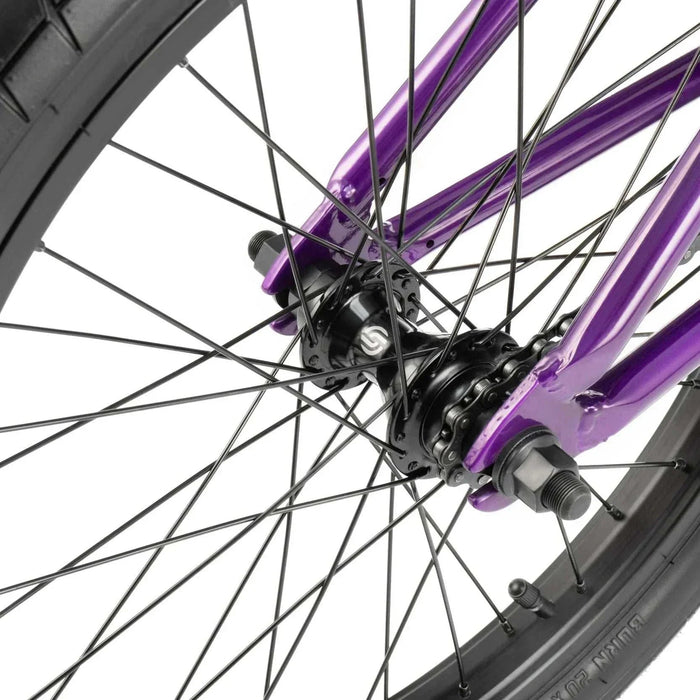 Close-up of the rear wheel hub and purple frame of the RADIO DARKO bike showing spokes and tire details
