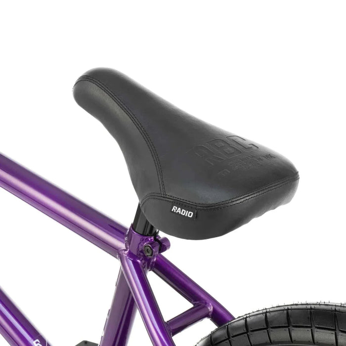 Close-up of the black padded seat on a purple RADIO DARKO bike frame designed for street riding