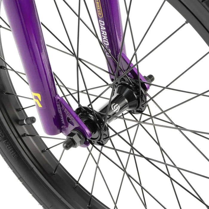 Close-up of the front wheel and fork of the RADIO DARKO bike in purple with black spokes and tire