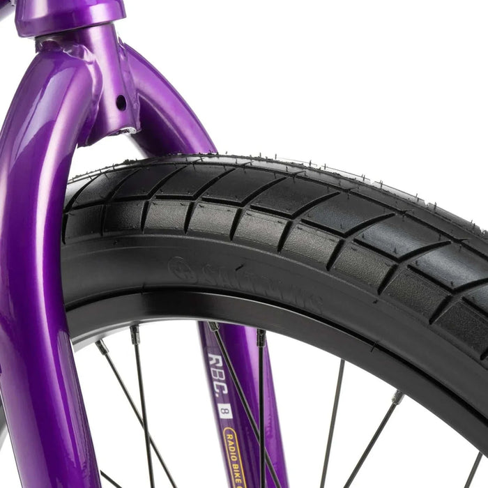 Close-up of purple RADIO DARKO bike front tire and fork with detailed tread and spoke design