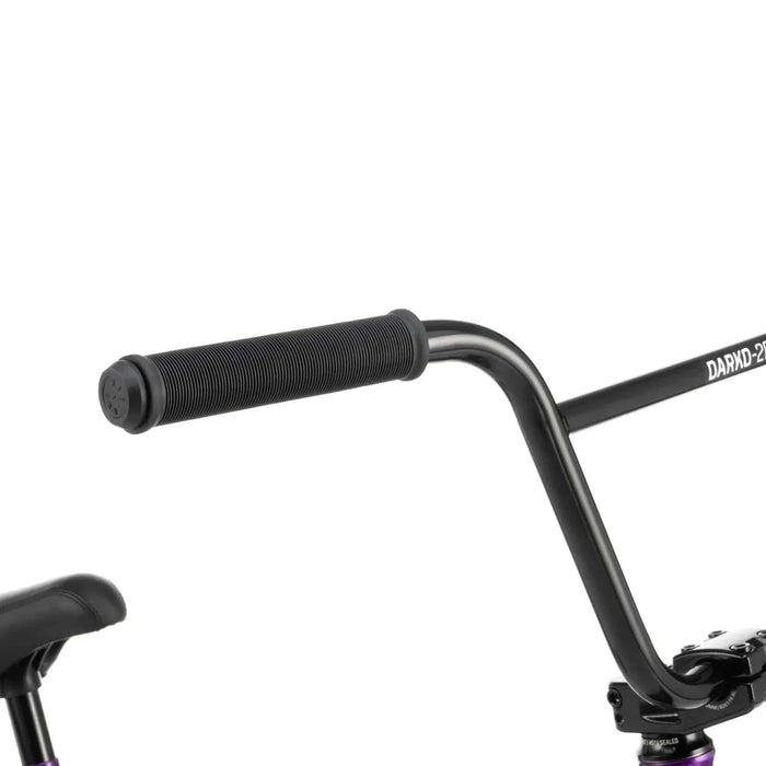 Close-up of RADIO DARKO bike black handlebar with flangeless grips and part of padded seat visible