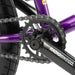 Close-up of the RADIO DARKO bike purple frame and black crankset with chain and rear tire.