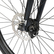 Close-up of the front disc brake and wheel of a black Radio LEGION 26 complete bike with 2.2" tires and alloy fork.