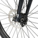 Close-up of the front disc brake and wheel of a black Radio LEGION 26 complete bike with 2.2" tires and alloy fork.