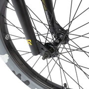 Close-up of the front wheel and fork of the RADIO DARKO bike showing black tapered hi-ten fork and Salt "BURN" tire