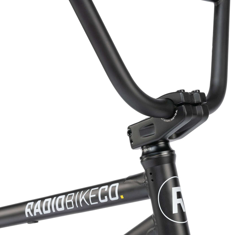 Close-up of RADIO DARKO bike matte black frame and handlebars with white logo lettering
