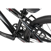 Close-up of the black Radio Raceline Helium Cruiser 24 complete bike frame and rear wheel components including chain, brake, and tire.