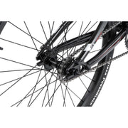 Close-up of Radio Raceline Helium Cruiser rear wheel, chain, and sprocket with black frame and detailed parts.