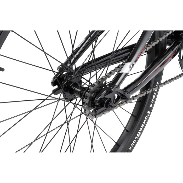 Close-up of Radio Raceline Helium Cruiser rear wheel, chain, and sprocket with black frame and detailed parts.