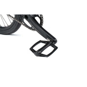 Close-up of Radio Raceline Helium Cruiser bike black pedal and crank arm on white background