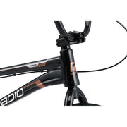 Close-up of Radio Raceline Xenon PRO bike frame and handlebars in black with copper accents