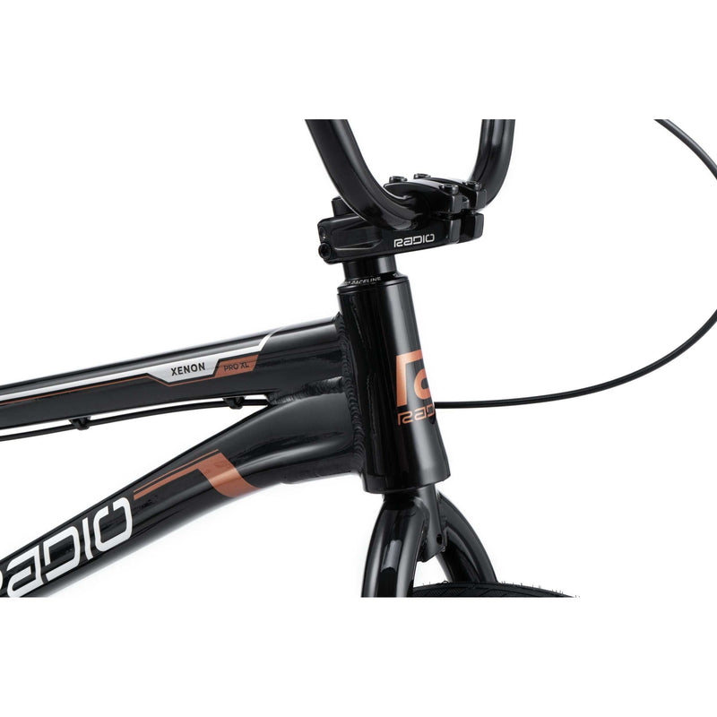 Close-up of Radio Raceline Xenon PRO bike frame and handlebars in black with copper accents