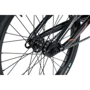 Close-up of Radio Raceline Xenon PRO complete bike's rear wheel, showing disc-ready dropouts, 43T alloy sprocket, KMC chain, and Argon PRO rim.