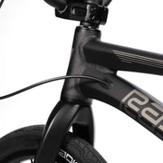 Close-up of the matte black RADIO RACELINE QUARTZ PRO bike frame and front fork with integrated cable routing and tubular tire.