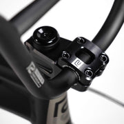Close-up of black RADIO RACELINE QUARTZ PRO 20" bike handlebar and stem with logo details