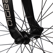 Close-up image of a black Radio Raceline Quartz Pro front wheel hub with spokes and carbon fork detailing