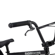 Close-up of black RADIO SAIKO 20 complete bike handlebars and frame with brake lever and seat visible