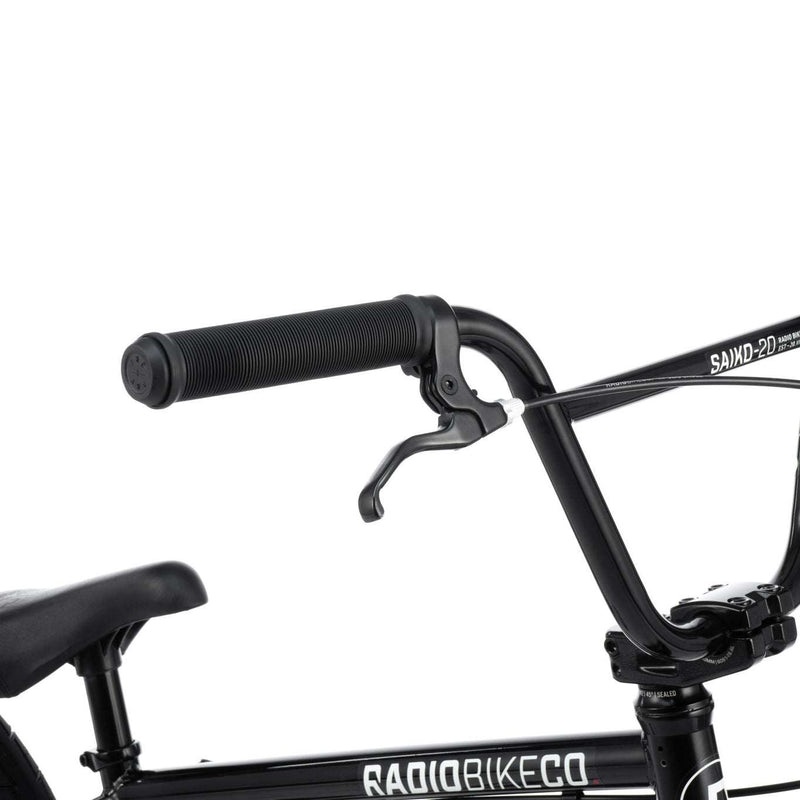 Close-up of black RADIO SAIKO 20 complete bike handlebars and frame with brake lever and seat visible