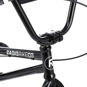 Close-up of black RADIO SAIKO 20 BMX bike handlebar and frame with logo detail