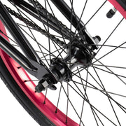 Close-up of RADIO SAIKO 20 bike rear wheel hub and black spokes with metallic purple rim