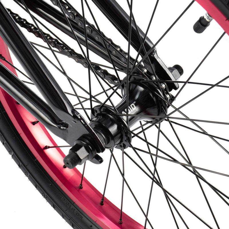 Close-up of RADIO SAIKO 20 bike rear wheel hub and black spokes with metallic purple rim
