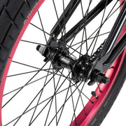 Close-up of RADIO SAIKO 20 bike rear wheel with black spokes and pink rim