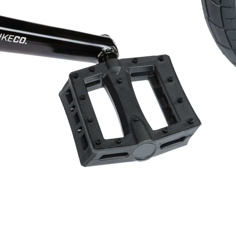 Close-up of the black RADIO SAIKO 20 bike pedal and crank arm on a BMX style bike