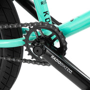 Close-up of the RADIO SAIKO 20 bike crankset and chainring on a turquoise frame
