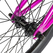 Close-up of the rear hub and metallic purple frame of the RADIO SAIKO 20 BMX bike wheel assembly.
