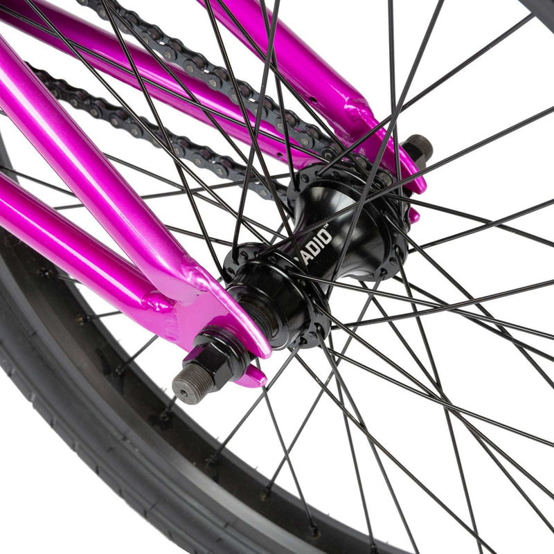 Close-up of the rear wheel and black RADIO hub on the metallic purple RADIO SAIKO 20 complete BMX bike.