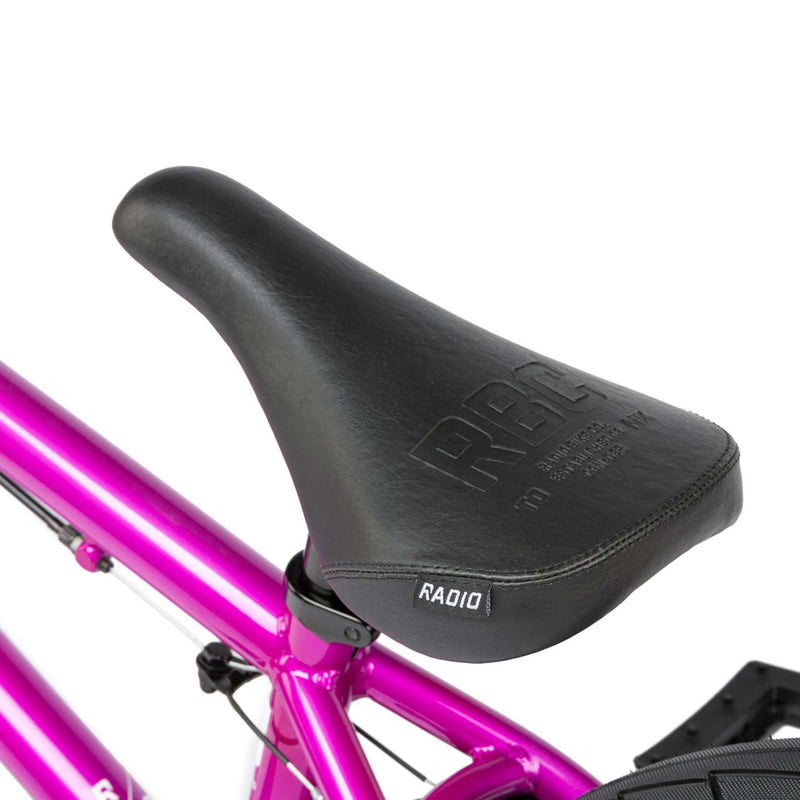 Close-up of black slim padded seat on metallic purple RADIO SAIKO 20 complete bike.