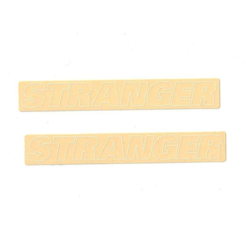 Two beige STRANGER outline stickers in a set with bold block letters on white background