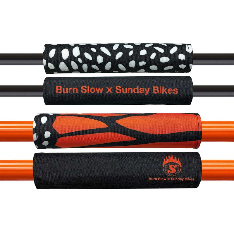 Sunday x Burn Slow reversible bar pad set with Monarch and branded designs on black and orange bike handlebars