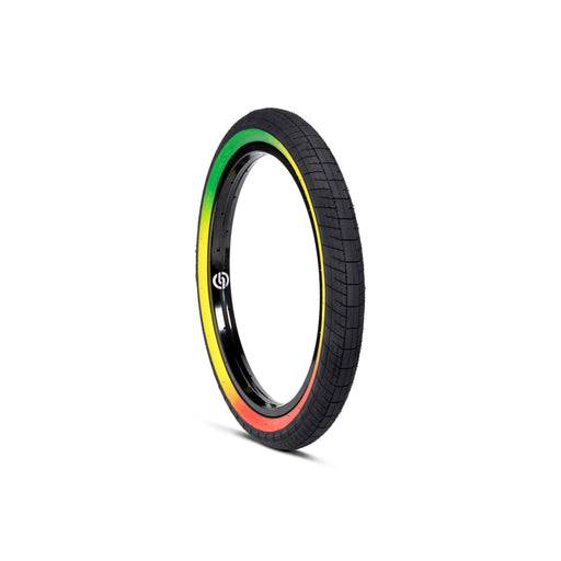 SALTPLUS STING TIRE 20-inch BMX tire with smooth center tread and rasta sidewall in black, yellow, red, and green colors.