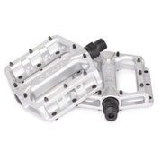 Slim alloy platform bicycle pedals with knurled body, replaceable steel pins, and crmo spindle, available in black, silver, and white.