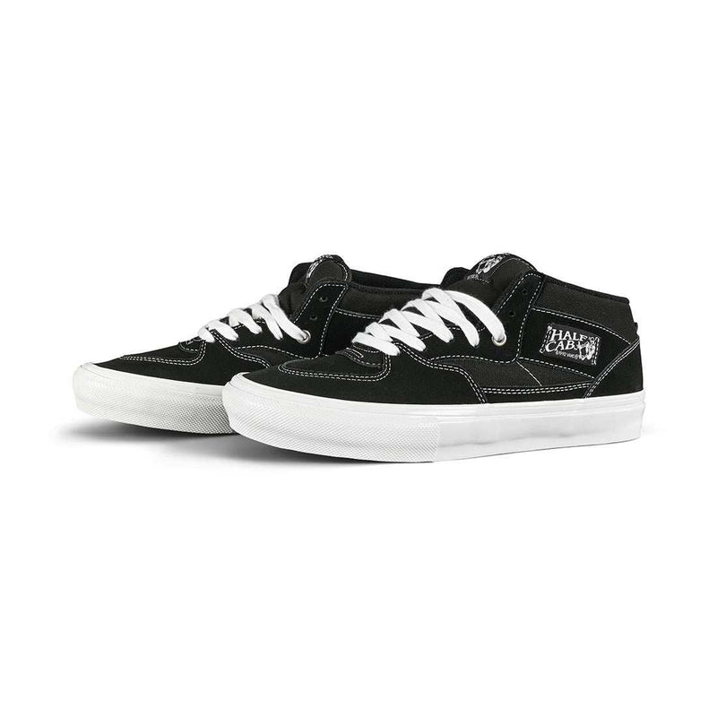 Black and white VANS SKATE HALF CAP shoes with suede and canvas upper, white laces, and durable rubber sole designed for skateboarding and BMX.