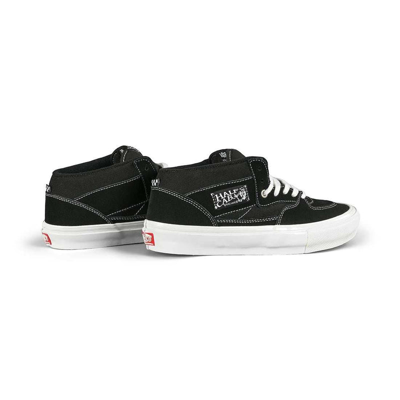 Black VANS Skate Half Cap shoes with white laces and soles, featuring suede and canvas construction and Steve Caballero signature design