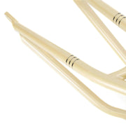 Close-up of beige WETHEPEOPLE PATHFINDER BMX frame detailing with smooth welds and curved chainstay designed for durability.