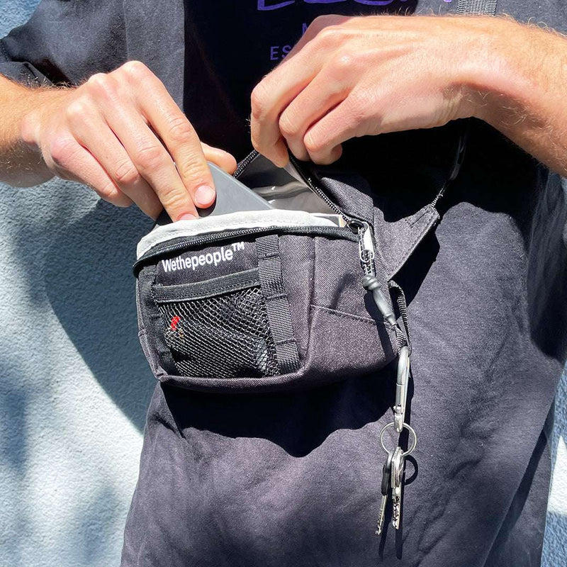 Wethepeople Street Pack black nylon waist bag with mesh pocket and zipper compartments being used outdoors